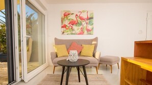 A modern living room with a sofa, a coffee table, and a wooden side table.