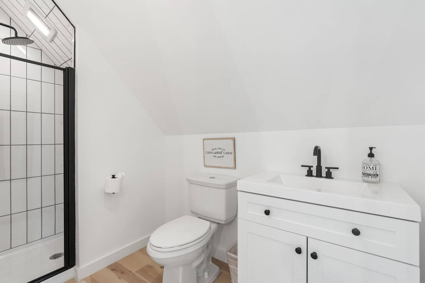 A bathroom with a shower, toilet, and sink.