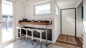 Cozinha moderna com área de bar embutida, uma janela e uma porta.