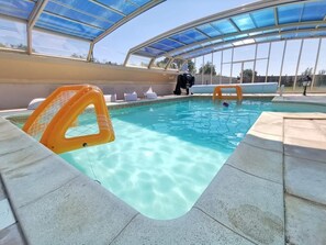An indoor swimming pool with clear water, a glass ceiling, and a lifeguard chair. - L'Antidote, estate with heated indoor pool 1h30 from Paris (Coulours)