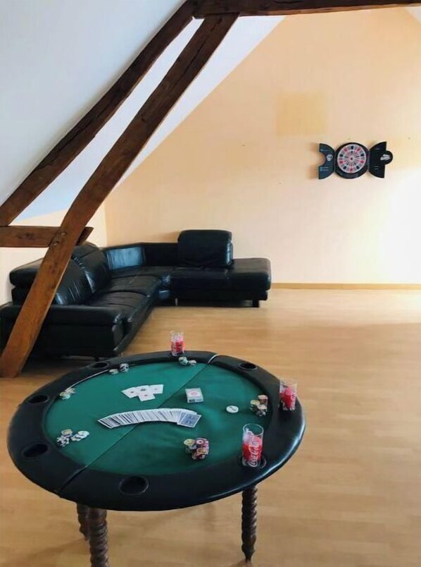 A room with a green poker table, a black leather couch, and a dartboard on the wall. - L'Antidote, estate with heated indoor pool 1h30 from Paris (Coulours)