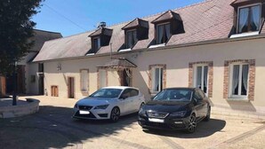 A two-story house with a driveway and two parked cars. - L'Antidote, estate with heated indoor pool 1h30 from Paris (Coulours)