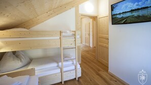 A wooden bunk bed room with a painting of a lake on the wall. - Premium Chalet # 8 with sauna and swim spa (Murau)