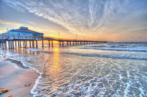 Stroll along the pier to the oceanfront building with a flat facade.