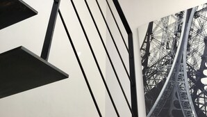 A modern staircase with black railings and a glass enclosure at the top. - Apartment in detached house (Colmar)