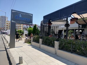 A restaurant named 'Danny' with outdoor seating, surrounded by decorative fencing and greenery.