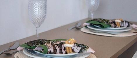 A dining table set with plates, cutlery, and a decorative centerpiece.