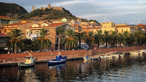 A coastal town with a historic fort on a hill, colorful buildings, and a waterfront with boats. - Large, Authentic 2-bed Apartment, Panoramic Views (Bosa)