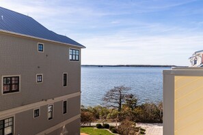 A multi-story building with a view of a body of water.