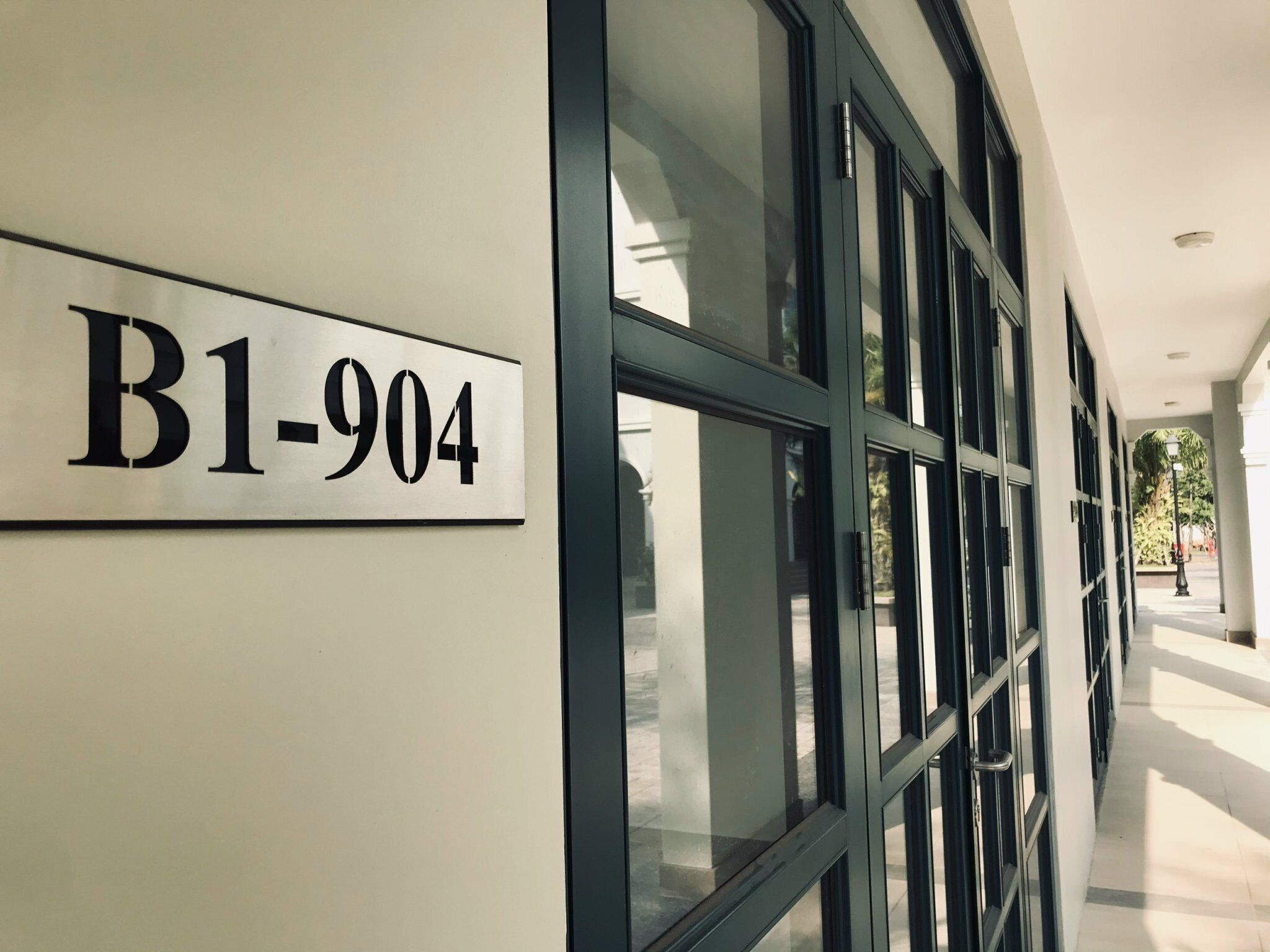 Ein Gebäudeeingang mit einem Schild, auf dem 'B1-904' steht.