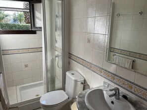 Shower, hair dryer, towels, toilet paper
