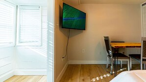 A room with a bed, a desk, and a TV mounted on the wall. - Cozy Cabin in a rural setting #10 In Temple, NH (Temple)