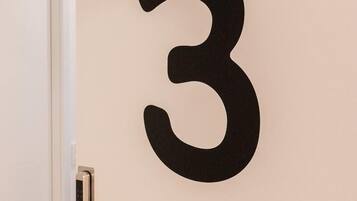 A door with a large black number "3" on the wall.