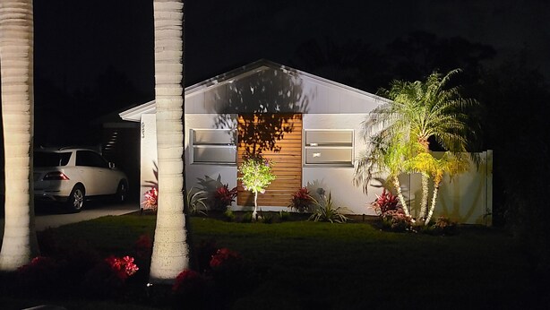A modern house with a garage, a driveway, and a well-maintained lawn. - Pool Home next to Ritz and Vanderbilt beach (Naples)