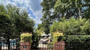 A gated entrance with a brick pathway leading to a covered area. - Downtown Hickory Lounge (Hickory)