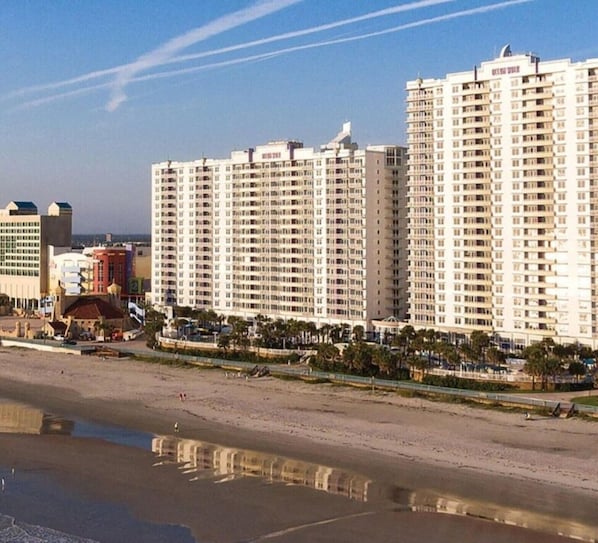 A beachfront hotel with multiple high-rise buildings, a sandy beach, and a clear sky. - Bike Week, 2027 March 5th through March 11th, 2027 ONLY (Daytona Beach)
