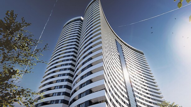 En moderne højhusbygning med en buet facade og flere balkoner.