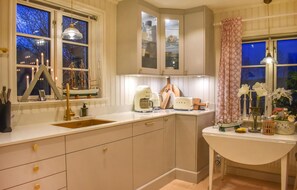 Enjoy cooking in this well-equipped kitchen with a sink, coffee maker, and ample storage.