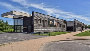 A modern building with a large glass entrance, a black facade, and a sign reading "Paleospace". - 1 bedroom gorgeous apartment in Blonville-sur-Mer (Blonville-sur-Mer)