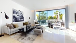 A modern living room with a large window, a white sofa, a coffee table, and a painting of a motorcycle. - Elegant La Cala Escape: Relax in Style in this Luxury Townhouse (La Cala de Mijas)