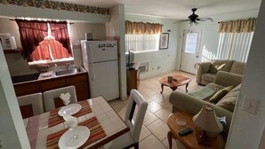 A compact living space with a kitchen, dining area, and a living room.