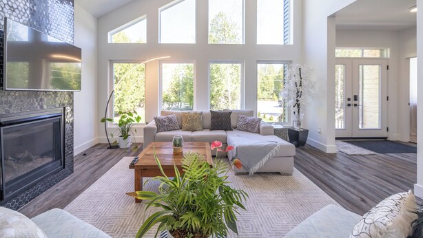 A spacious living room with a fireplace, large windows, a sofa, and a coffee table. - Luxury oasis in the woods, less than five minutes from the beach! (Wiarton)
