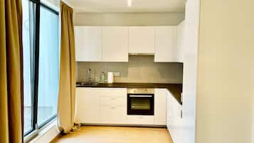Design Apartment, 2 Bedrooms | Private kitchen | Full-sized fridge, oven, coffee/tea maker, electric kettle