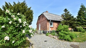 A brick building with a cobblestone pathway leading to a door. - "Haus Seegang" approx. 100 sqm, close to the beach and with a large garden (Neubukow)