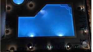 A room with a large, illuminated pool, a circular window, and a seating area with tables and chairs. - Welcome to our Beach Dream View, The Sunrise and Sunset are breath taking (Gulf Shores)