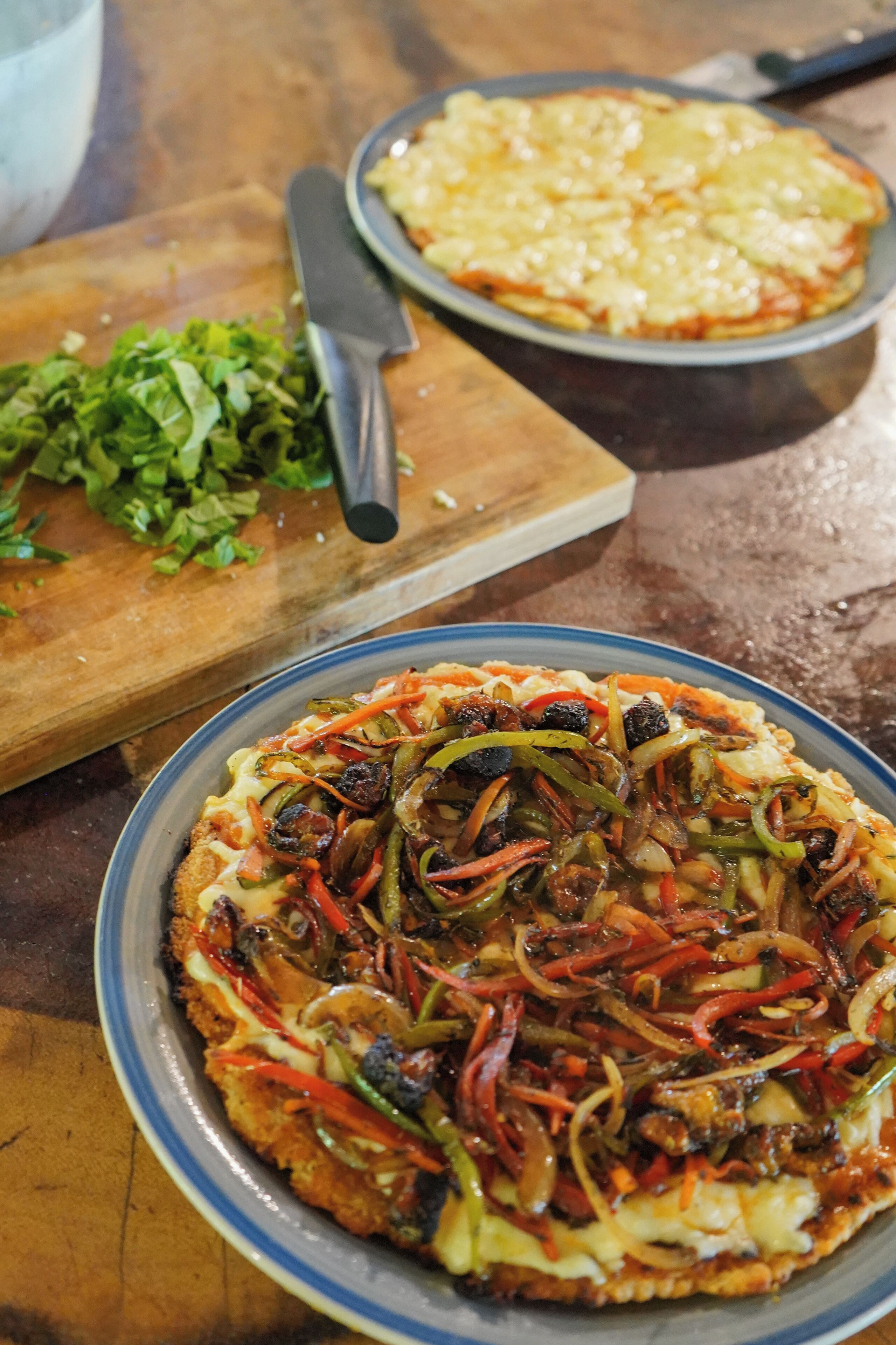 A pizza with various toppings on a plate.