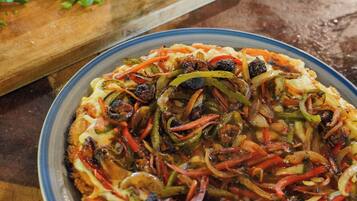 A pizza with various toppings on a plate.