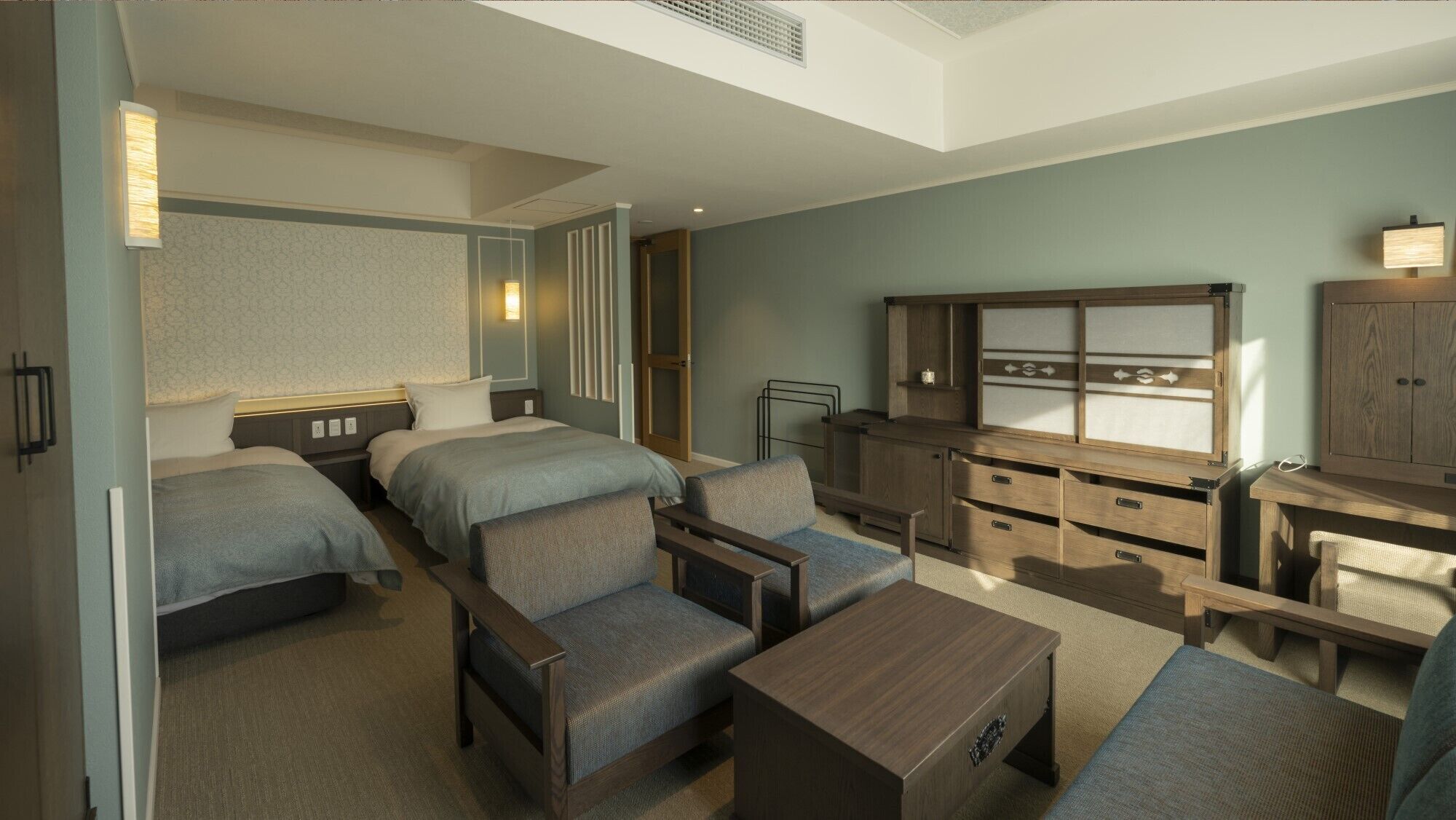 A hotel room with two beds, a desk, a chair, a small table, and a cabinet.