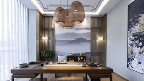 A dining area with a long wooden table, chairs, and hanging woven light fixtures. - Qing Dao bu ke bu zhu hotel (Qingdao)