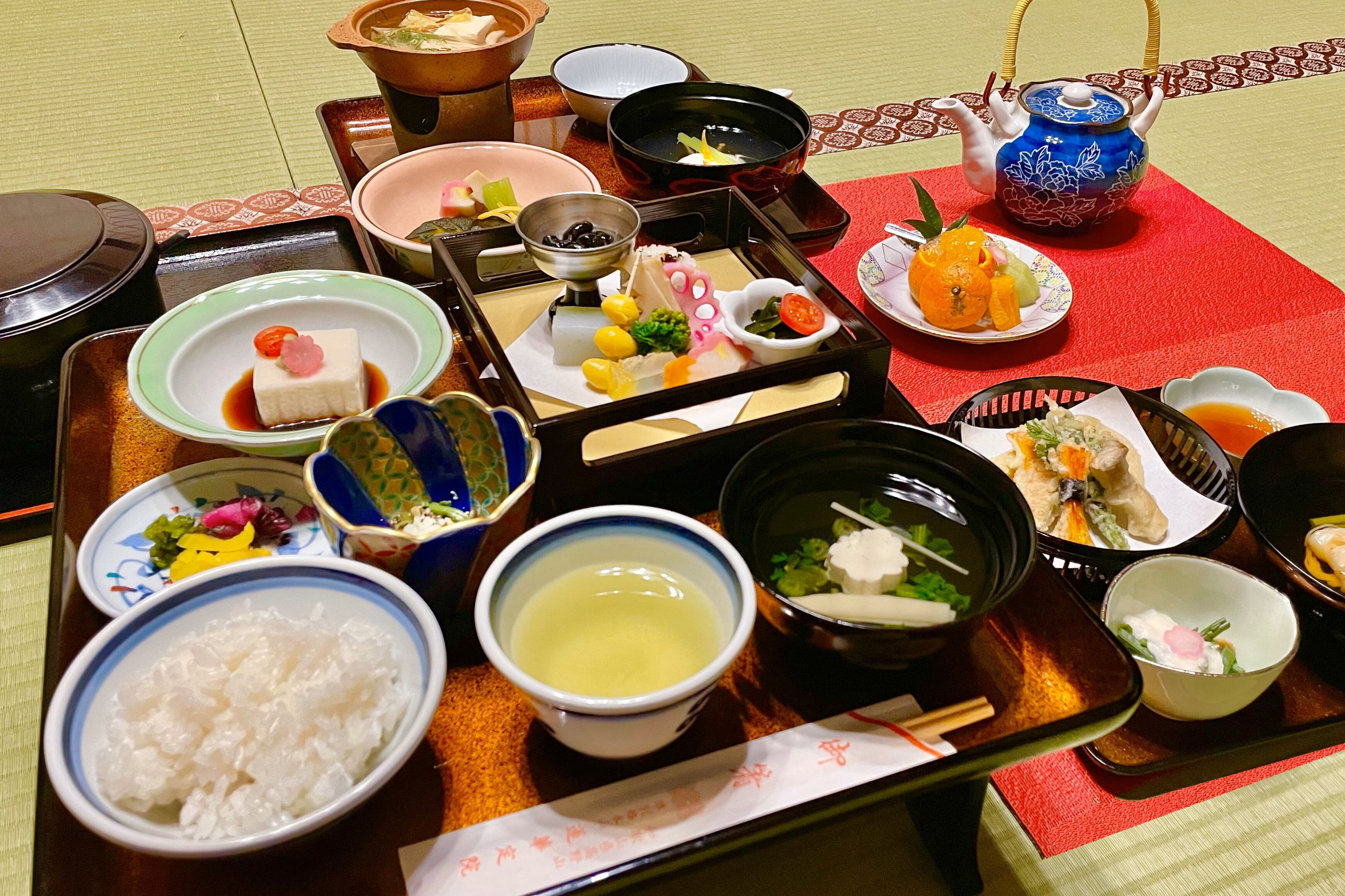 A traditional Japanese meal set with various dishes and utensils on a tray.
