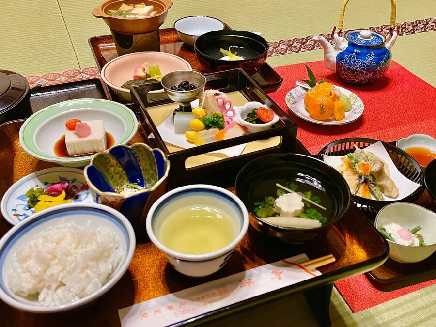 A traditional Japanese meal set with various dishes and utensils on a tray.