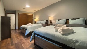 A hotel room with two beds, a wardrobe, and a door leading to another room. - #9 - *STUNNING*RENOVATED* *4BR HOUSE* (Southington)