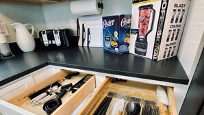 A kitchen drawer with utensils and appliances.