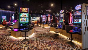 A casino with slot machines and bar seating. - Nightcap at Empire Hotel (Kilburn)