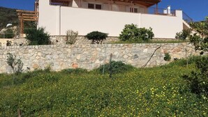 A two-story house with a stone wall and a red-tiled roof. - Immaculate 3-Bed House in Ermioni (Ermioni)