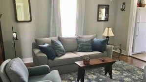 A living room with a sofa, armchair, and coffee table. - Farmhouse Cottage local Horse farms, Distilleries, Winery Tours, walking trails. (Frankfort)