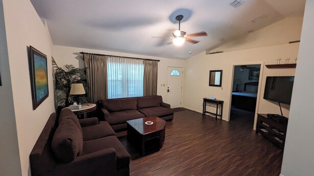 A living room with a sectional sofa, a coffee table, a ceiling fan, and a television. - Country Retreat in North Central FL Oasis w/ Firepit, WiFi & Nearby Springs (Old Town)