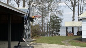 A basketball hoop in a driveway with a lake view. - Lake Marion Lakehouse with 180° lake view (Elloree)