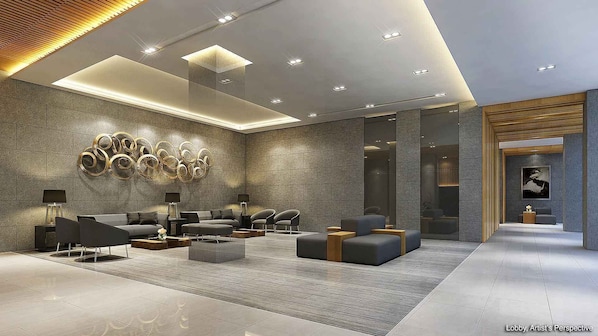 A modern lobby with a seating area, a wall with circular patterns, and a wooden panel on the right.