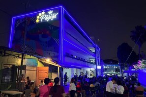 A building with a neon sign reading "Payaya" and a stage set up for an event. - Hotel Payaya Candelaria de la Frontera (Candelaria de la Frontera)