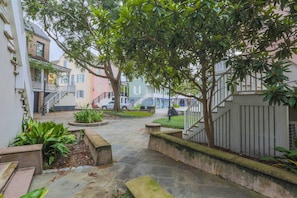 Stroll through the serene courtyard, surrounded by lush greenery and beautifully maintained architecture.