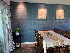 Enjoy meals with family and friends in this cozy dining area, complete with a long table and matching chairs.