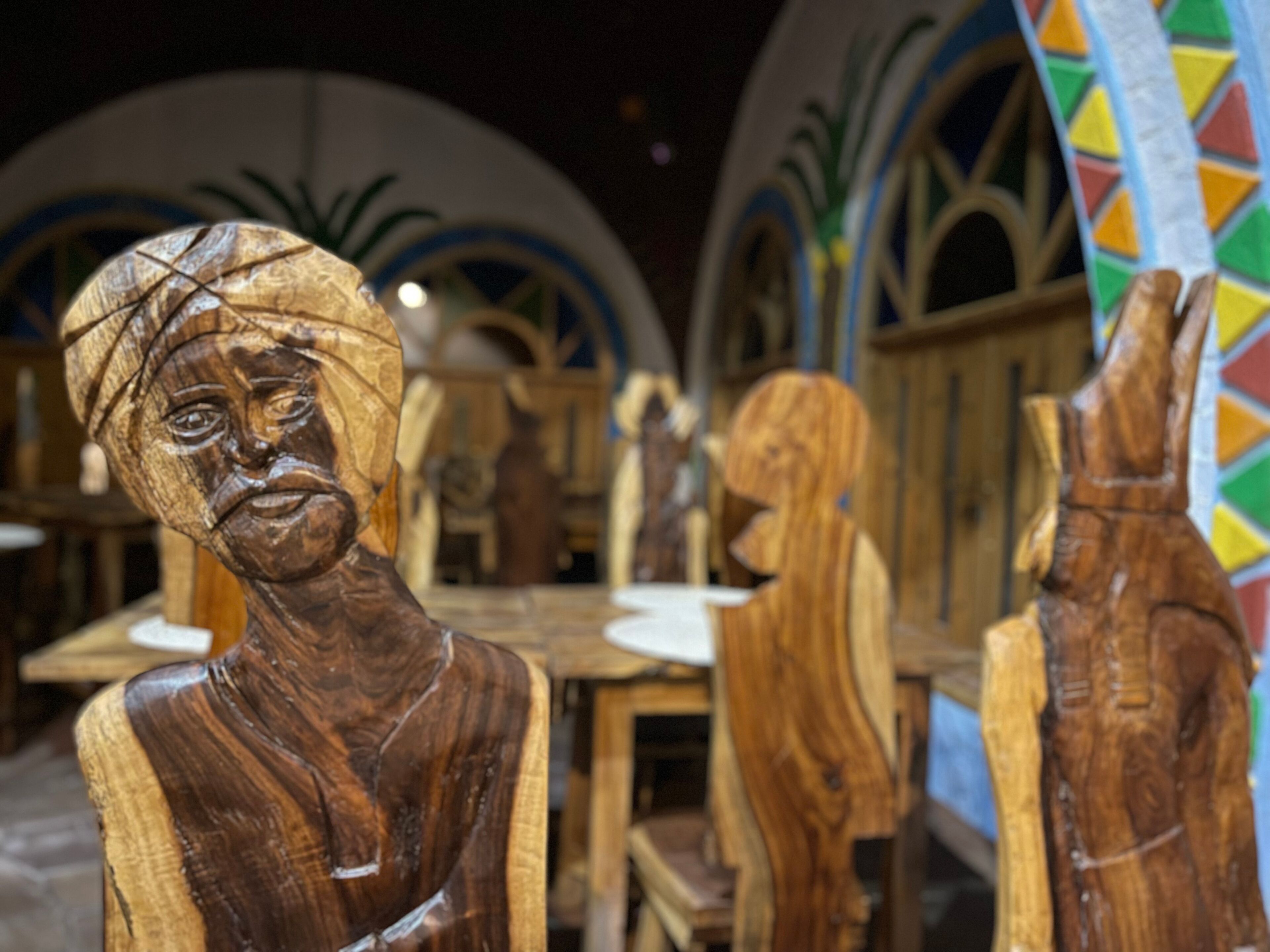 Wooden sculptures in a workshop setting.
