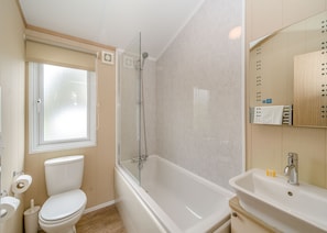 A bathroom with a toilet, a bathtub, a shower, a sink, and a window. - 2 bedroom accommodation in Bewaldeth, Keswick (Bewaldeth, Keswick)