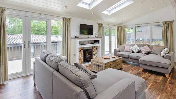 A spacious living room with a fireplace, a television, and a balcony with sliding doors. - 2 bedroom accommodation in Wootton Bridge, Nr Cowes (Wootton Bridge, Nr Cowes)