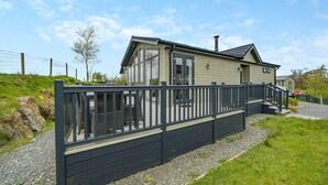 A modern two-story house with a balcony, a chimney, and a fenced yard. - Wordsworth Premier Select (Bewaldeth, Keswick)